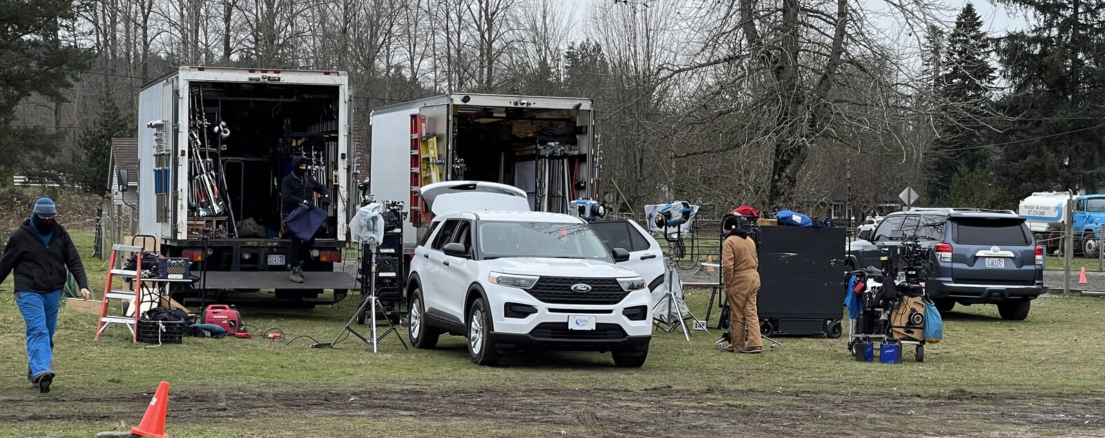 IMI production basecamp — grip trucks, lighting, and crew staging on location
